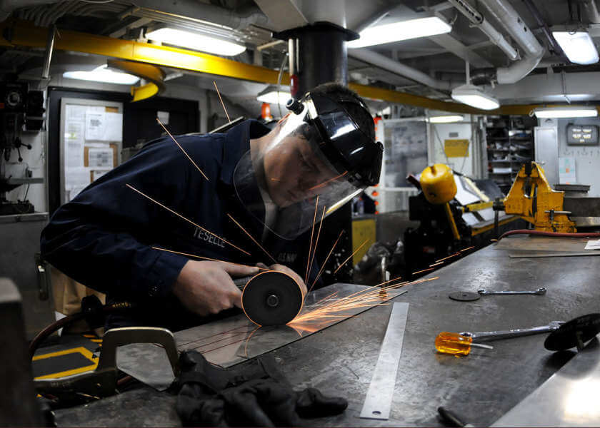 A US Navy technician using a pneumatic tool. Small and large machinery can both cause HAVS