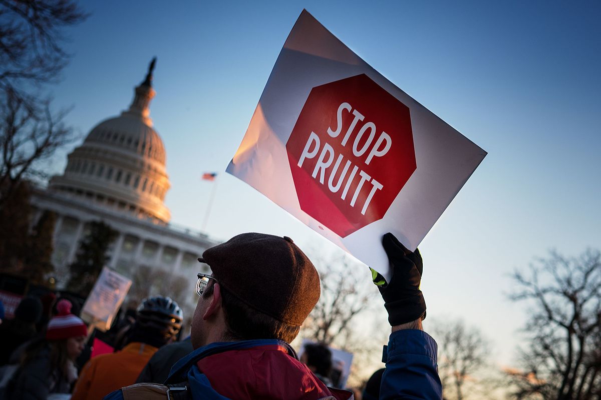 A man protesting the appointment of former EPA chief Scott Pruitt