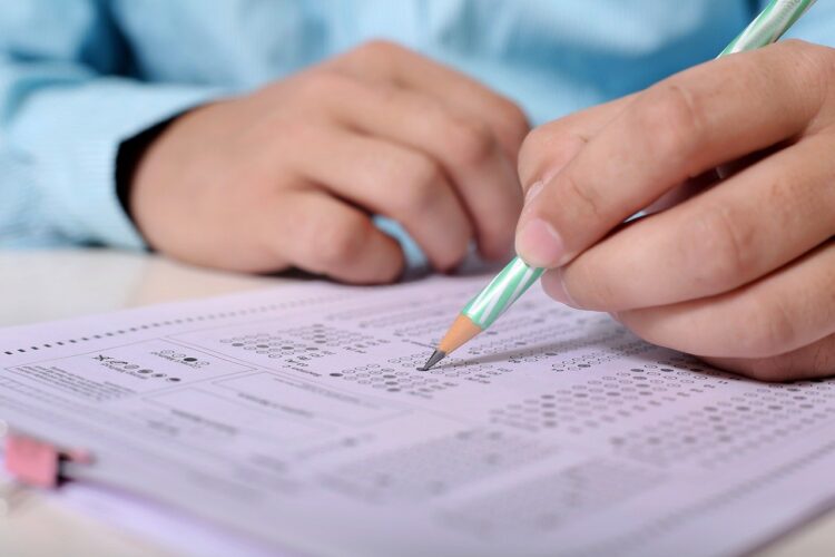 man taking exam with pencil